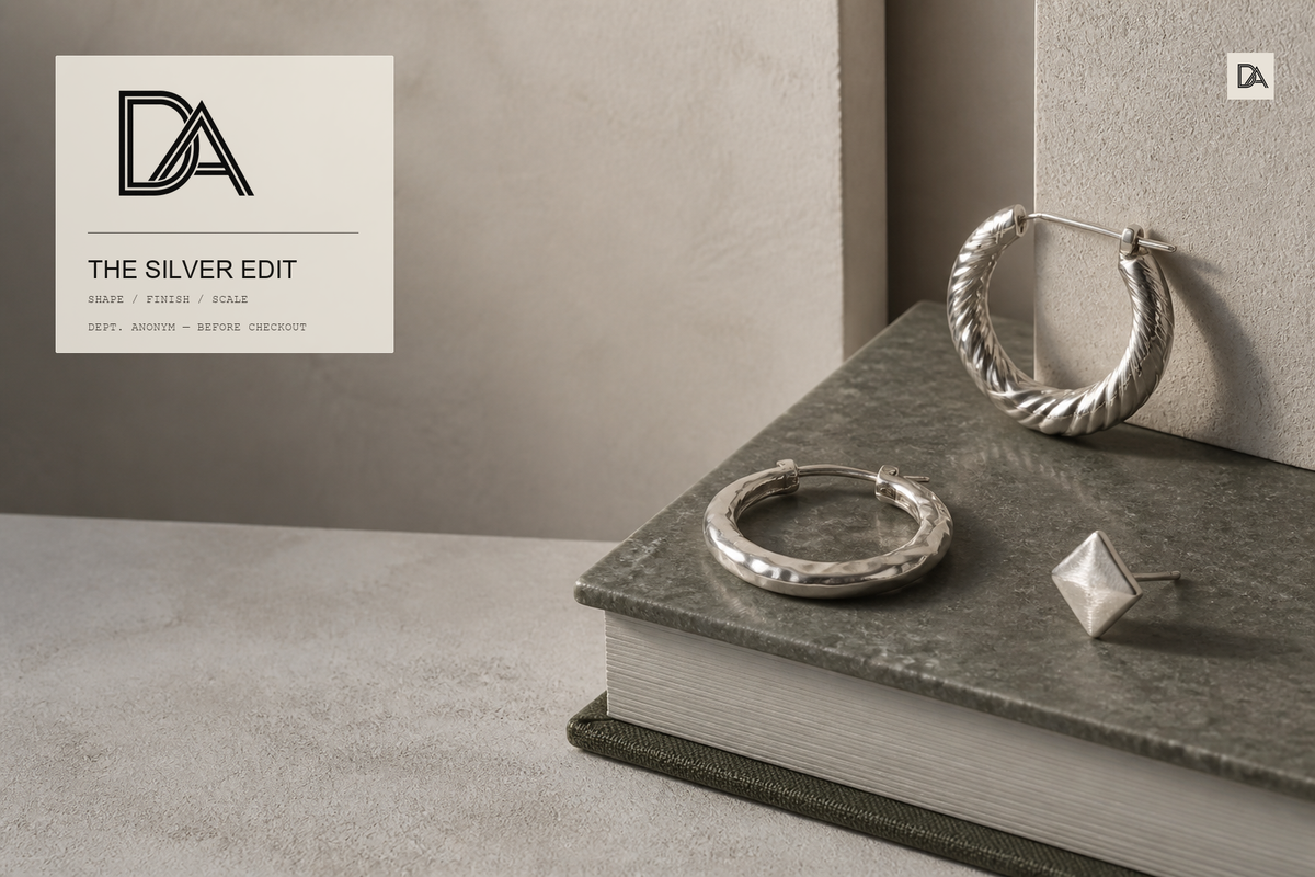 Original Dept. Anonym editorial still life of three silver earrings showing a twisted hoop, carved hoop and diamond-shaped stud, with the approved DA logo lockup and a small DA editorial mark.